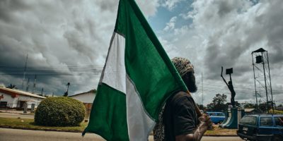 Man holding a Flag of Nigeria