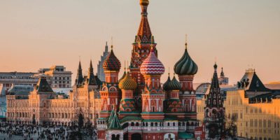 Stunning view of St. Basil's Cathedral in Moscow during sunset with a bustling crowd.