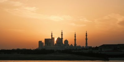 the sun is setting over a large city